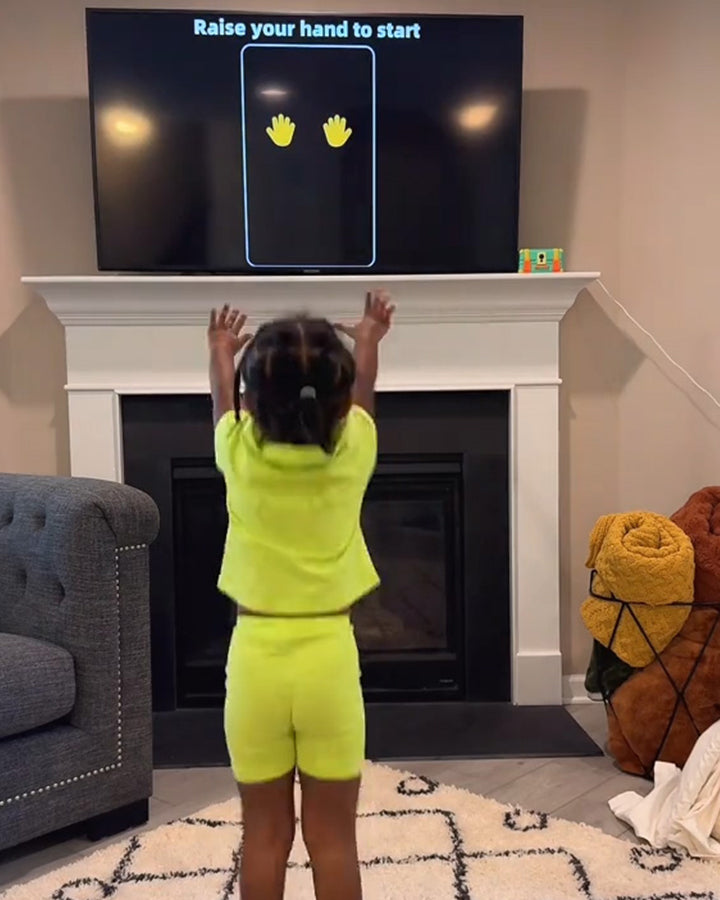 Child engaging with Wonder Trek motion sensor family game.